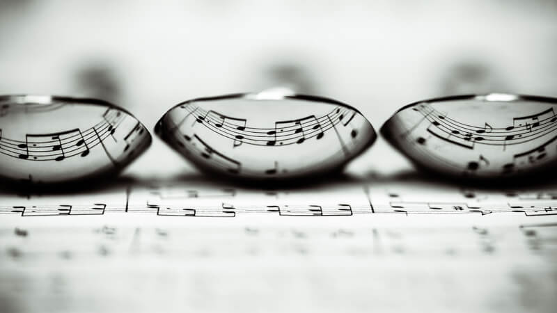 still life photography lenses on sheet music