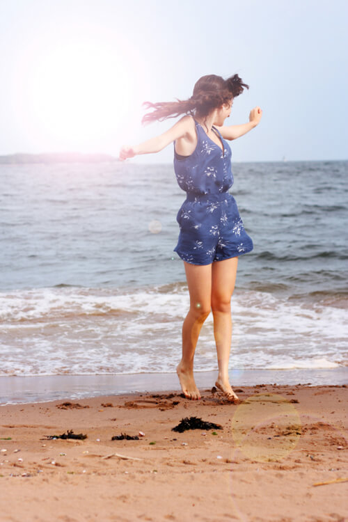 lens flare photography with girl jumping on the beach lens flare photography with girl jumping on the beach