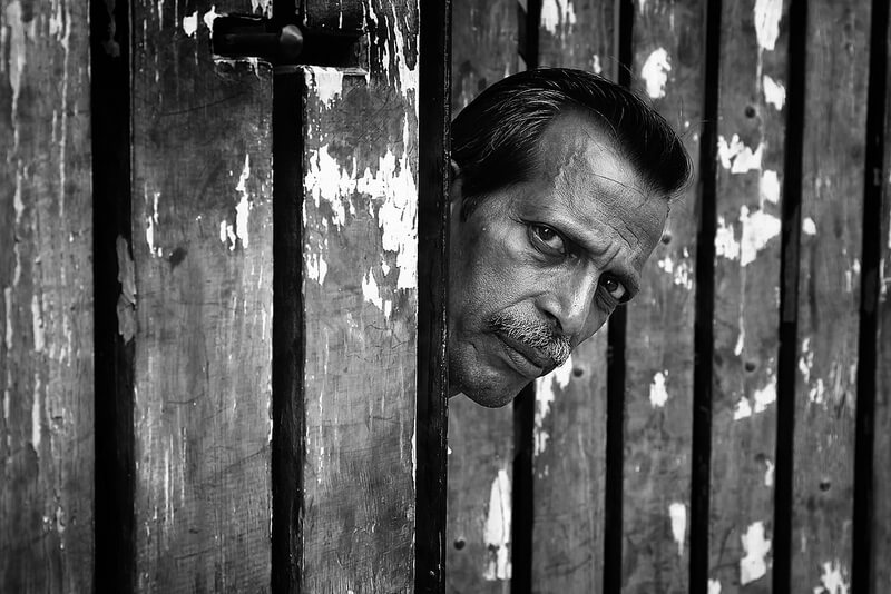 man behind fence