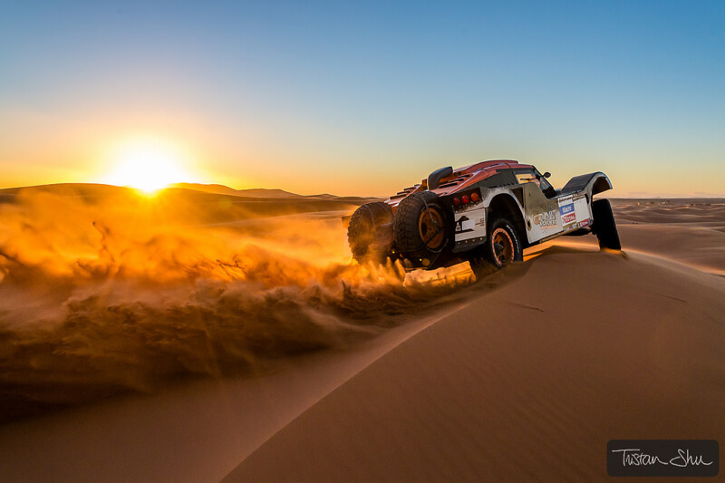 rally car racing through the Merzuga desert