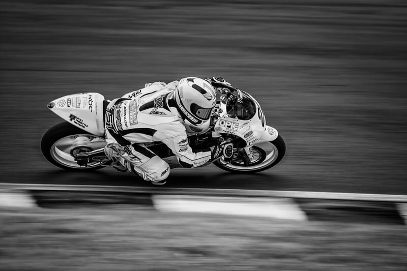 motorbike racer going low through a corner