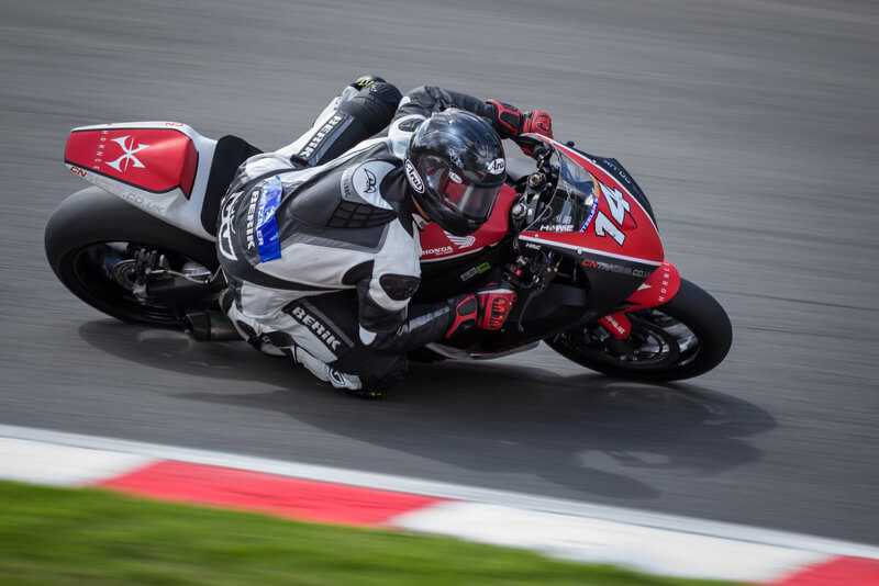 motorbike racer going low through a corner
