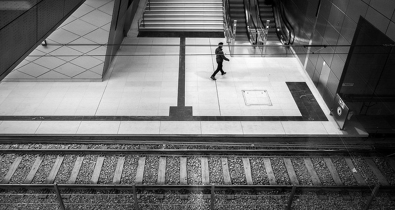 a man photographed through a window at a subway station in Düsseldorf
