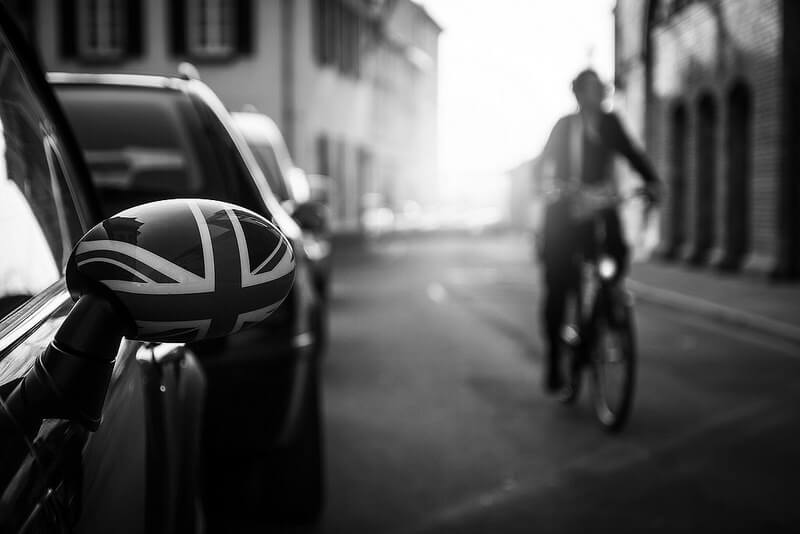 car mirror with union jack and man on a bicycle