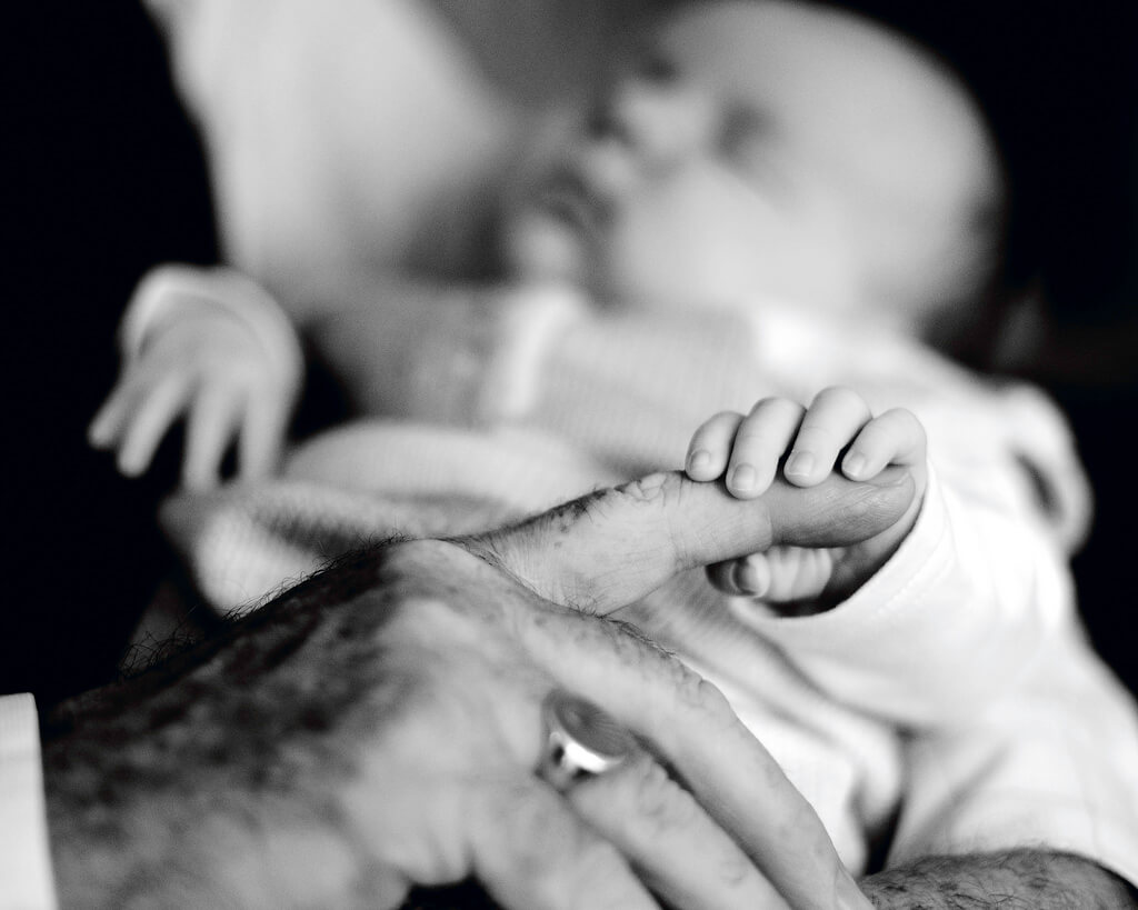 Conor Ogle - baby holding Grandpa’s finger