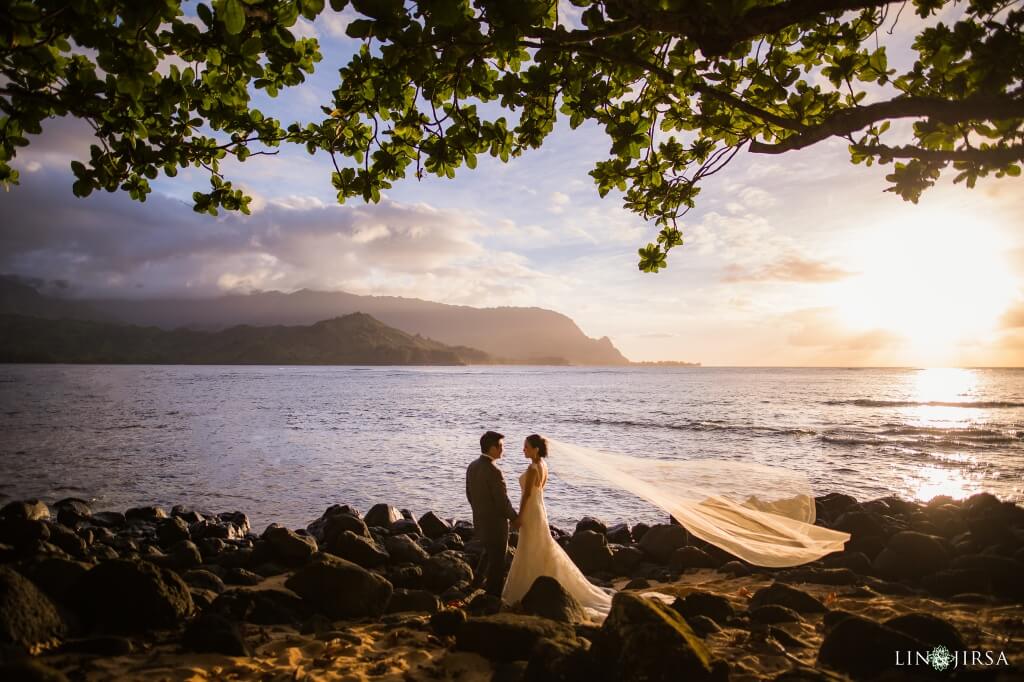 Couple stands in front of ocean in Hawaii
