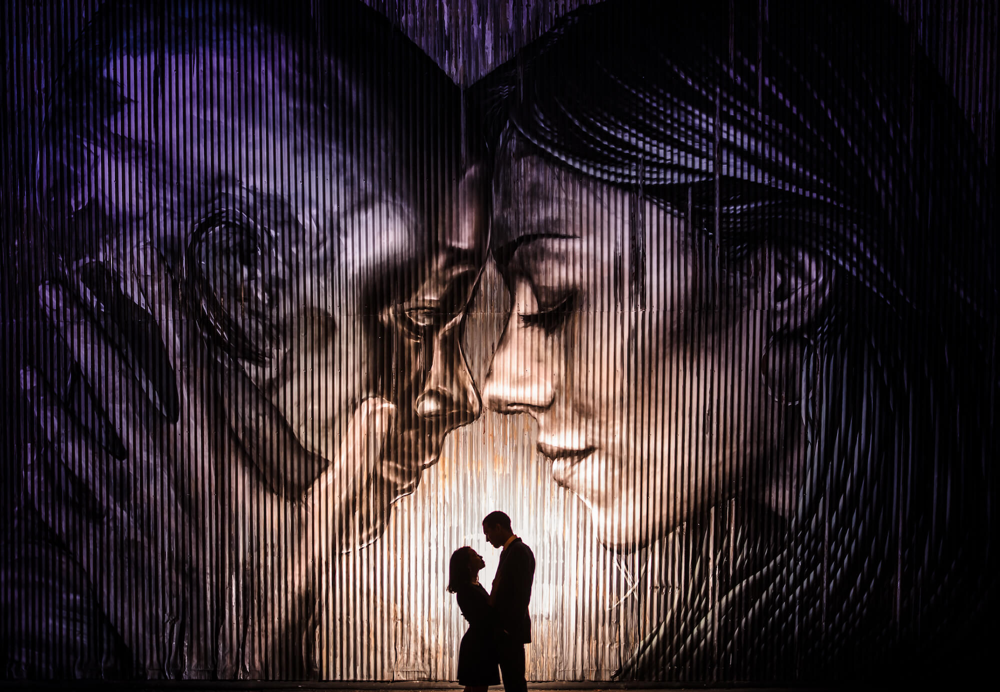 Couple in front of mural