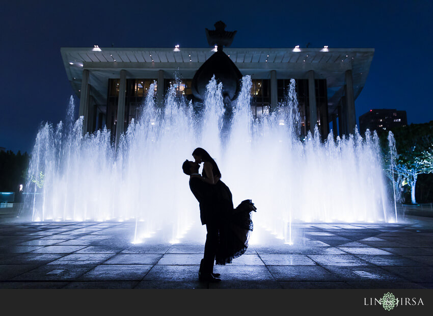 negative space photography couple in front of fountain